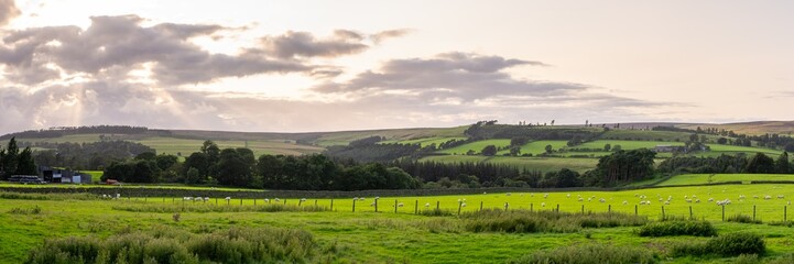 Fototapeta na wymiar panoramic view of a sunset across a Cumbrian landscape, Cumbria, UK