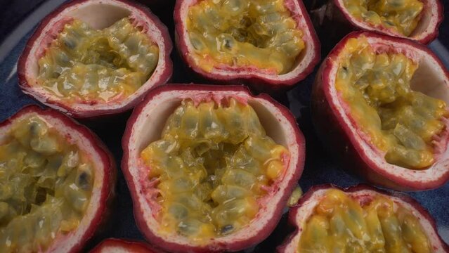 Close up rotating passion fruits, juicy tropical maracuya, exotic fruits, 4K macro shot