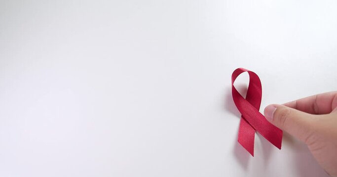 Placing a red ribbon on the right side of the frame which signifies the HIV-AIDS worldwide disease awareness and prevention.