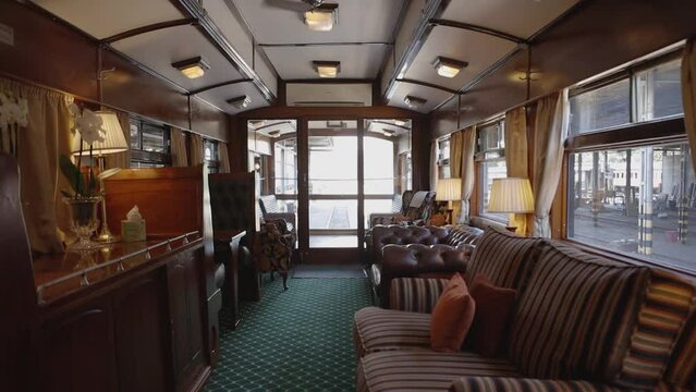 Amidst the rhythmic clatter of rails, an observation car on a luxury train reveals panoramic splendors. Every detail, from plush seating to gleaming interiors, promises an unparalleled journey