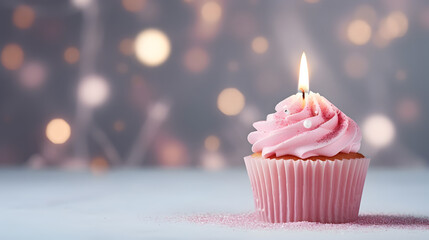 Small pink colored birthday cake with candle