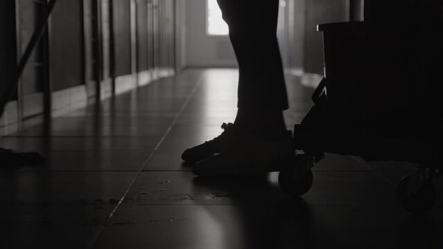 Selective Focus On Unrecognizable Janitor Mopping Floors With Cleaning Supplies Near Trolley