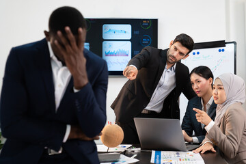group of business people pointing and talking rumor spread behind stress colleague at workplace, diverse coporate employee gossip and bully black person while meeting in financial office