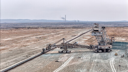 Fototapeta na wymiar Open pit coal mine with huge backhoe digger
