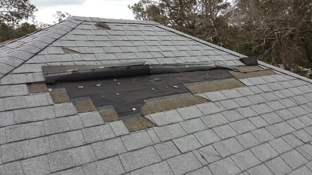 House roof damage from strong hurricane storm winds and rain water for insurance claim