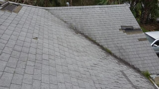 Water damage to the house roof from strong hurricane storm winds pending insurance claim