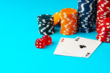 Playing cards and poker chips on blue background