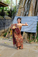 Traditional dancer performing in a temple courtyard in Bali, Indonesia