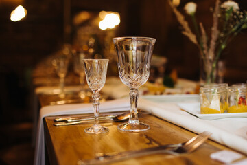 Restaurant table glassware background. Crystal wine glass. Crystal glass vodka shot.Cozy atmosphere rustic restaurant. Counstryside style.
