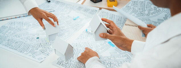 Worker, architect and engineer work on real estate construction project oratory planning with...