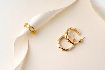 Golden jewelry ring on ribbon studio shot
