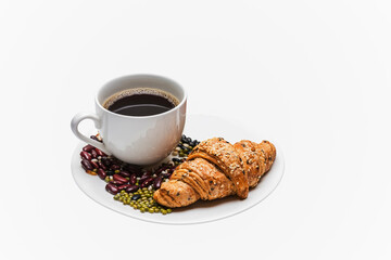 Black coffee with homemade croissants on white background.