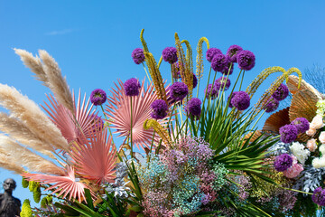 A bouquet of purple flowers against a blue sky