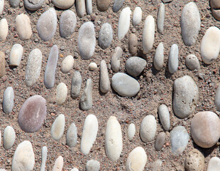 Pebble road as an abstract background. Texture