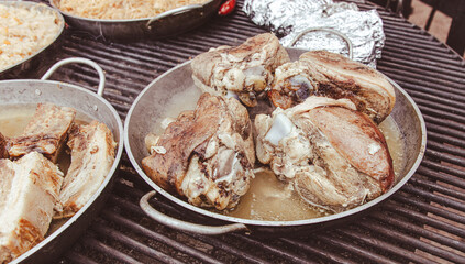 The meat is fried in a frying pan on the grill