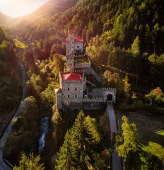 Latzfons, Italy - Aerial view of sunrise at beautiful Gernstein Castle (Castello di Gernstein, Schloss Gernstein) in South Tyrol at summer time with green foliage and sunrays