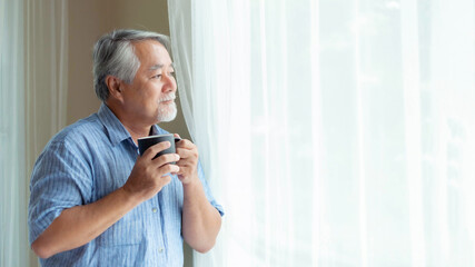 Senior male , old man feel happy drinking coffee in the morning, enjoying time in his home indoor background - lifestyle senior happiness concept