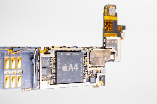 Kyiv, Ukraine - August 25, 2023: Apple iPhone 4 motherboard with A4 processor, close-up on a white background