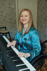 Smiling disabled woman using wheelchair playing piano