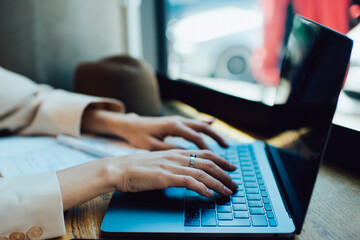Crop female freelancer typing on keyboard