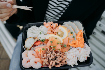 plate with seafood in hands