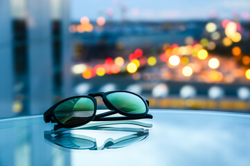 Blue Cityscape Reflected on Table with Sunglasses and Architecture