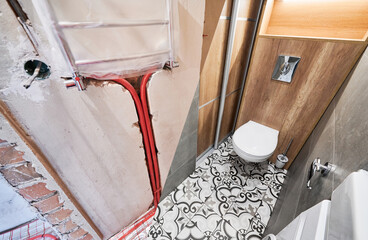 Comparison of washroom lavatory before and after renovation. Old apartment restroom with underfloor...