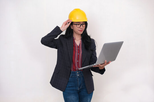 Female project engineer checking data from laptop in her hand