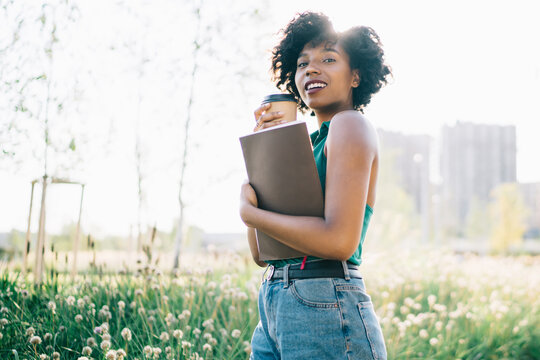 Half length portrait of attractive female teengaer with textbook with copy space area