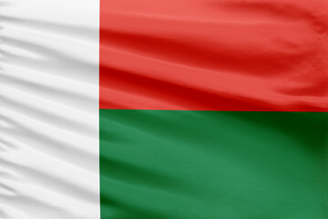 Madagascar flag background is depicted on a sport stitch cloth fabric with folds.
