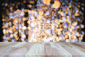 Wooden table top (counter bar) with Blurred background of Christmas Tree with Decoration christmas lights. Banner for advertise on online media. For montage product display visual layout.