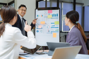 Businessmen team or financial data analysts working with tablets and laptop computers and data graphs together. Plan to analyzing projects in the office.