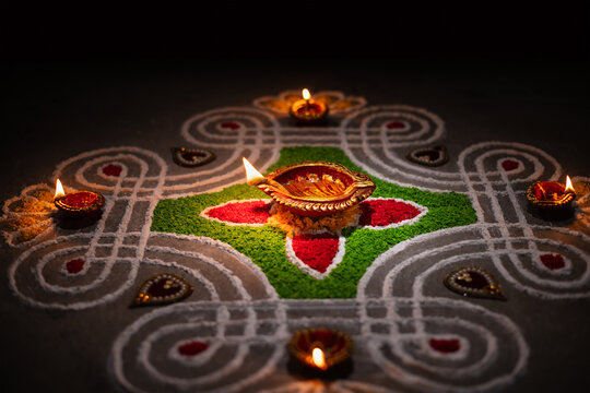 Clay diya lamps lit during diwali celebration, Diwali, or Deepavali, is India's biggest and most important holiday.
