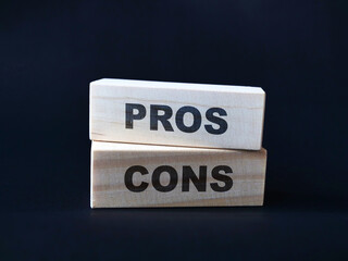 Pros and cons, text words typography written on wooden blocks, business life and self development
