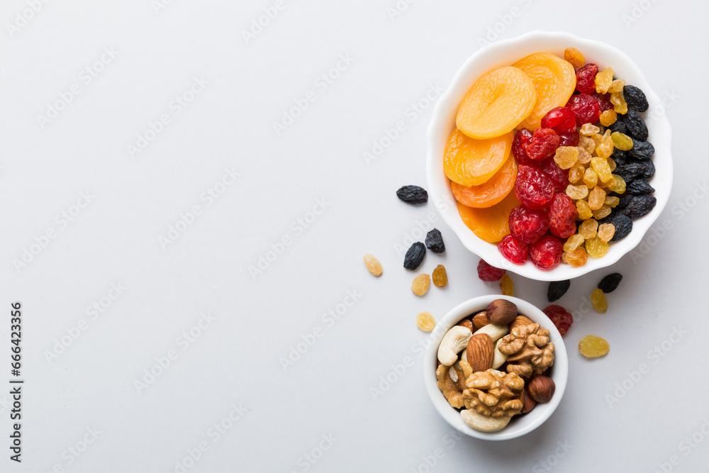 Wall mural healthy snack: mixed nuts and dried fruits in bowl on table background, almond, pineapple, cranberry, cherry, apricot, cashew - Wall murals
