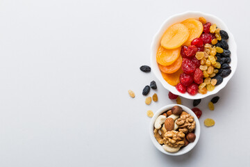 healthy snack: mixed nuts and dried fruits in bowl on table background, almond, pineapple, cranberry, cherry, apricot, cashew
