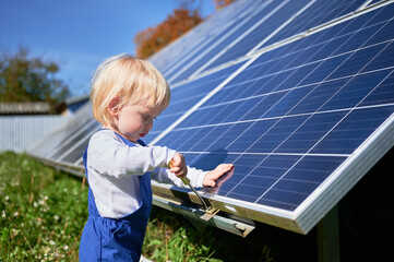 Curious boy learning how does solar panel work. Small kid interested in using different tools....