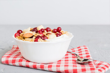 Healthy breakfast food with granola, yogurt, fruits and nuts. Dessert parfait with dried fruits for breakfast