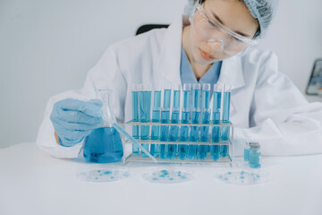 Female scientist researcher conducting an experiment working in the chemical laboratory.