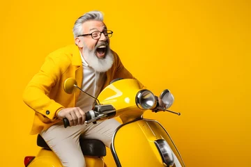 Foto op Canvas happy mature man riding scooter on yellow color background. © Pacharee