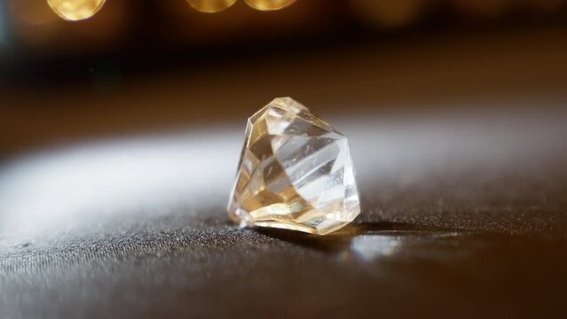 Dramatic diamond illumination a captivating diamond, bathed in dramatic lighting, shines brilliantly. The interplay of shadows and highlights accentuates its exceptional facets High quality 4k footage