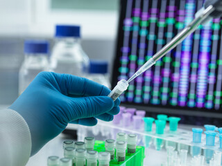 Scientist pipetting DNA sample into vial for testing