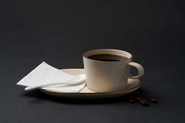 Black coffee and coffee beans on black background