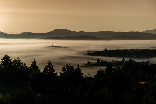 View of a foggy valley during sunrise, next to the town Kupres in Bosnia and Herzegovina.