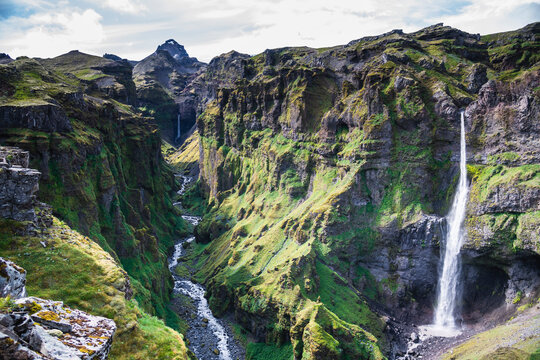 View of a beautiful waterfall along the canyon in southern region of Iceland.