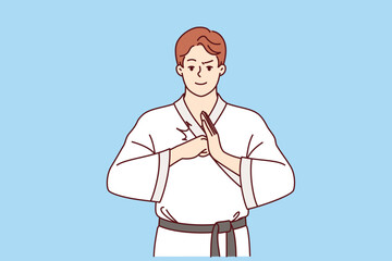 Man fighter in karate or taekwondo clothes makes welcoming gesture to invite opponent to start fight. Guy is interested in karate and studying self-defense techniques to maintain sports lifestyle © drawlab19