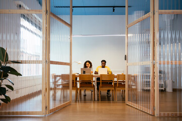Young students studying and using laptop at university
