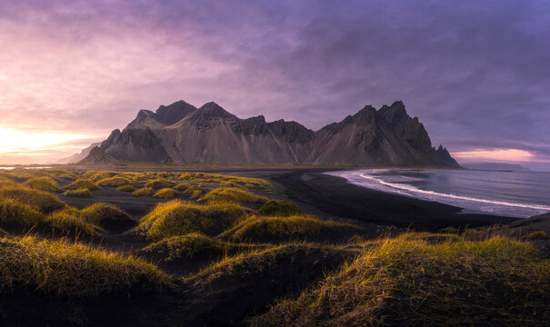 Panorama shot of Vestrahorn mountain with black sand beach in Stokksnes peninsula during sunset in southeastern Iceland.