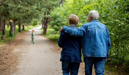 Affectionate elderly couple walking together in forest