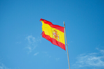 Spanish flag on cloudy sky